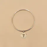 Esclava rígida de plata 925 con dije redondo con el símbolo de la medicina en plata y oro.