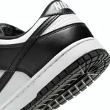 Zapatilla deportiva Nike Dunk Low Retro, color blanco y negro, con revestimientos de cuero, puntera perforada y suela de goma.