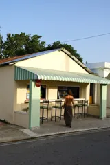 Falda larga tejida color vino tinto con brillo dorado, de corte ajustado y abertura lateral en la pierna.