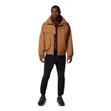 Campera Columbia Powderkeg II color marrón con interior rojo. Cuenta con tecnología Omni-Tech™ impermeable y transpirable, sistema de intercambio con cremallera, forro reversible con aislamiento sintético, cierre frontal con solapa, cremallera frontal de doble sentido, bolsillos interiores y exteriores con cremallera, y puños ajustables.