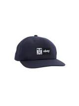 Gorra de béisbol azul marino de seis paneles con logo Obey bordado en blanco en el frente.