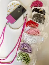 Correa para celular de soga trenzada en color fucsia con terminales metálicas plateadas y mosquetón.