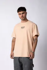 Remera color durazno de algodón lavado con estampa frontal con la frase "Coffee Break is the best kind of break".