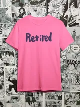 Remera rosa con estampado de la palabra "Retired" en color azul.