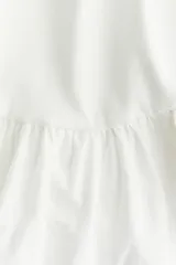 Musculosa corta blanca de punto de algodón con escote en U, breteles anchos y bajo globo en popelina de algodón.