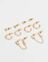 Set de aros dorados con strass, cadenas y dijes de estrellas.