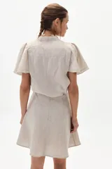 Minifalda color beige de lino con corte evasé.