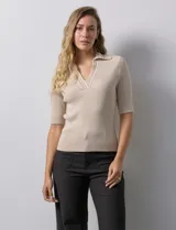 Blusa en tejido acanalado color beige, marca Rio & Rian. Cuello solapa y escote en V en tejido calado.