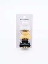 Set de tres pinzas para el pelo tipo clip, con cuerpo dorado y superficie en negro con glitter, amarillo con glitter y blanco con glitter.