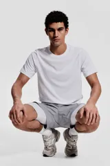 Remera deportiva blanca de corte estándar, con cuello redondo y mangas cortas. Confeccionada en tejido funcional DryMove™ que ayuda a absorber el sudor.