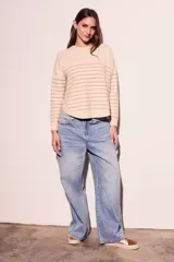 Sweater color crema con rayas horizontales finas color marrón claro, de corte holgado y mangas largas.