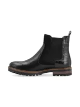 Botín de caña corta color negro, de origen europeo, con combinación de materiales: cuero croco, cuero snake y cuero nobuk. Presenta elásticos laterales al tono y forro de pelo sintético.