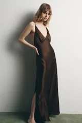 Vestido largo marrón de satén con escote en pico, tirantes finos dobles y espalda descubierta. Cierre lateral con cremallera oculta.
