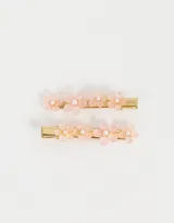Set de dos hebillas para el pelo doradas con apliques de flores de resina color rosa y perlas.