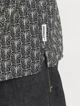 Camisa de manga corta Jack & Jones con cuello clásico, corte amplio y estampado de hojas en tonos grises. Confeccionada en tejido twill con mezcla de viscosa LENZING™ ECOVERO™ y nylon.