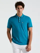 Polo azul con cuello tipo camisero, mangas cortas con ribete en contraste y bolsillo de parche en el pecho.