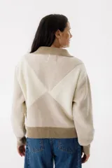 Campera bomber azul con diseño geométrico en color mostaza, cierre frontal y bolsillos laterales.