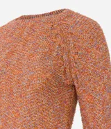 Suéter de punto melange color naranja con hilos metalizados, cuello redondo y mangas largas raglán.