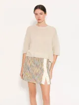 Sweater tejido con lurex, color beige, de silueta holgada y estilo remerón, con mangas cortas.