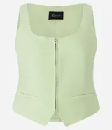 Chaleco corset de sastrería color verde claro, con escote en U, cierre frontal con cremallera, bolsillos falsos y bajo en V.