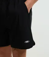Bermuda masculina de tejido tecnológico color negro, con ruedo redondeado y cintura elástica con cordón interno. Presenta etiquetas aplicadas en la parte trasera y lateral.