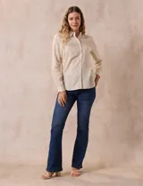 Camisa a rayas verticales finas color beige y blanco, marca Alex & Jordan. Tiene cuello con solapa, abertura central con botones y bolsillo aplicado en el pecho.