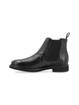 Botín Chelsea de cuero negro con elástico lateral, suela de goma y logo grabado.