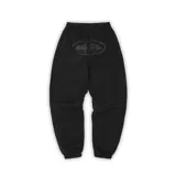 Pantalón de jogging negro con cordón ajustable en la cintura, tobillos ajustados y estampado con el logo de la marca en el muslo.