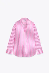 Camisa de popelín a rayas verticales rosas y blancas, de corte holgado, con cuello solapa, escote pico y mangas largas con puños abotonados.