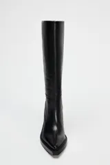 Bota de cuero negra con caña alta, punta cuadrada y tacón ancho.