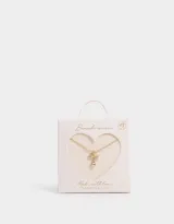 Cadena corta dorada con dije de moño con piedras de zirconia y dije de corazón colgante.