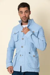 Cazadora celeste de lino con cuello alto, cierre frontal con botones, cuatro bolsillos frontales con solapa y cintura ajustable.