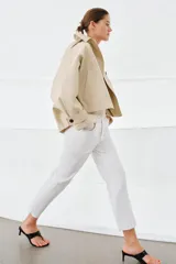 Jeans de tiro medio con corte flare y largo cropped. Presentan diseño de cinco bolsillos, trabillas en la cintura, raya planchada en el delantero y bajo desflecado. Cierre frontal con cremallera y botón.