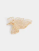 Broche dorado para el pelo con diseño de moño y apliques de strass.