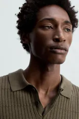 Polo color verde oliva de corte regular, tejido de punto con mezcla de algodón y cashmere. Tiene cuello solapa con cierre frontal de botonadura, manga larga y acabados en rib.