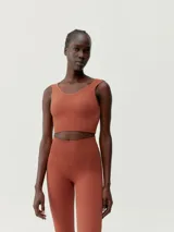 Top cropped verde de sujeción media, sin costuras, con tejido Fit_Tech con tecnología 3D, juego de texturas y hombros anchos. Diseño elegante y favorecedor con copas extraíbles.