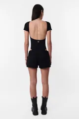 Body negro de algodón con lycra, cuello redondo y espalda descubierta. Mangas cortas y calce slim.