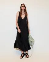Vestido maxi negro de lino delavé con escote en V con puntilla de algodón, tiras regulables en los breteles y tres tajos en los laterales y delantero.