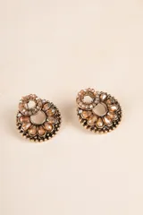 Aros de metal en forma de flor con detalles en tonos dorados y perlas.
