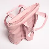 Bolso tote rosa claro de material sintético, con asas de cinta tejida y bolsillo exterior frontal.