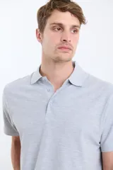 Remera manga corta verde con cuello polo y tapeta con botones.