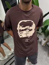 Remera marrón de algodón con estampado frontal de una cara distorsionada y la leyenda "FUTUREPROOF®".