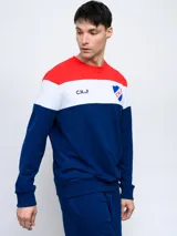 Buzo de felpa con cortes y cambios de color rojo, blanco y azul. Incluye el escudo del Club Nacional de Football y las siglas C.N.deF.