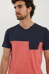 Remera de hombre con cuello en V, parte superior negra y parte inferior gris con bolsillo en el pecho.