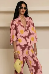 Camisa confeccionada en algodón con estampado de flores color rosa y marrón. Cuello mao con detalle de volado y manga tres cuartos.