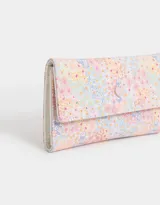 Billetera de cuerina con estampado de flores, fresas y cerezas. Tiene formato de fichero con solapa y broche en forma de corazón. Cuenta con compartimentos para tarjetas y billetes.