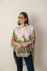 Camisa italiana de viscosa estampada con diseño abstracto en tonos azul, amarillo y verde sobre fondo natural, de corte irregular y mangas 3/4.