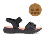 Sandalias negras de cuero con ajuste de velcro y elástico.
