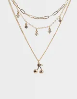 Collar corto dorado de múltiples cadenas con dijes de strass y cerezas.