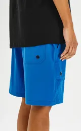 Bermuda azul francia de calce relax-fit, con bolsillos delanteros con fuelle, cintura con elástico y cordón de ajuste. Tejido Water Repellent de nylon y spandex.
